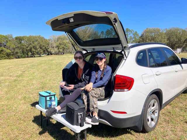 Volunteers scribing dressage from the back of a car on a clear day